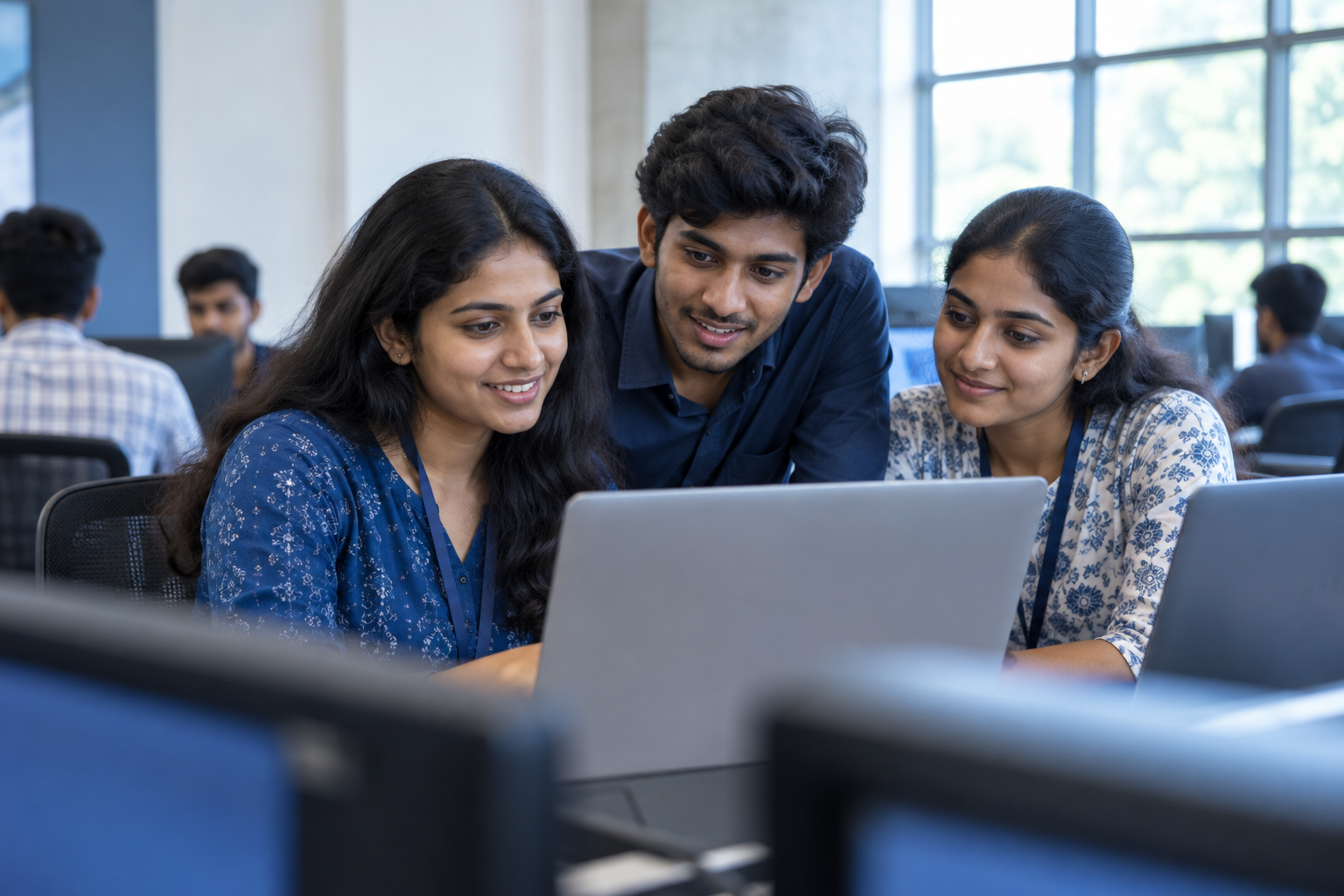 Illustrative image of engineering students collaborating on laptops